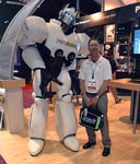 An image of OH&S Editor Jerry Laws next to a giant Pure Safety robot.