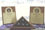 Plaques and an American flag honor FSIS Compliance Officers Jean Hillery and Thomas Quadros, killed in the line of duty June 21, 2000.