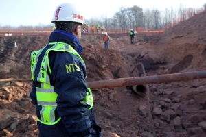 NTSB Member Robert Sumwalt scanes the site of pipeline rupture in Sissonville, W.Va. (NTSB photo)