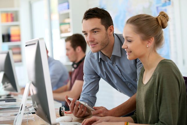 teacher and student working on computer