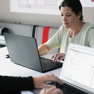 adult students working on laptops