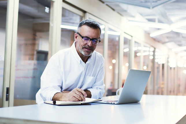 professor working on laptop