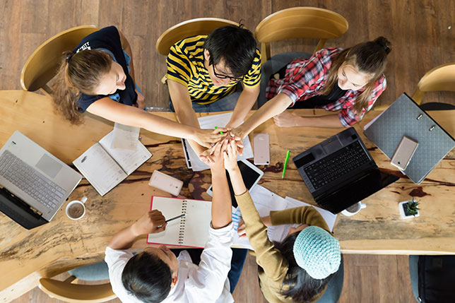 group of students high fiving