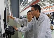 Tan Huan (front), section manager of Planning, and Dai Lan, Inventory Control manager, confer while working in the Jabil Shanghai facility. (Jabil Inc. photo)