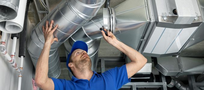 Worker installing HVAC system