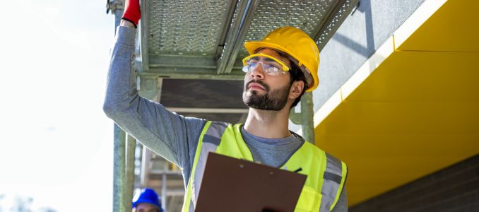 Engineer inspecting scaffolding on construction site