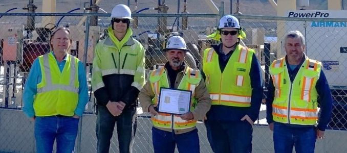 K.G. Walters employees holding award