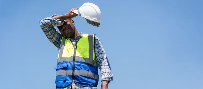 Tired Construction Worker Wiping Sweat Under the Hot Sun