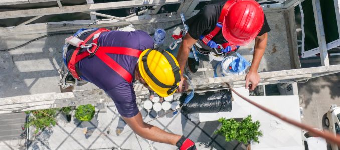 workmen on a suspended platform or cage