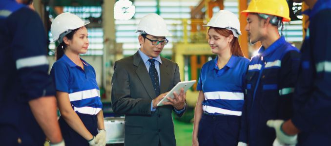 Production manager lined up the workers assigned tasks and instructed them to perform their duties carefully emphasizing safety