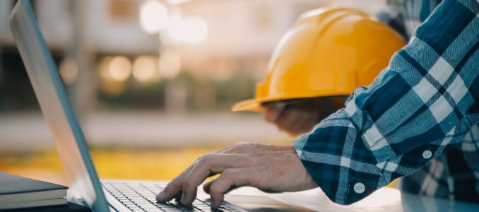 Worker with hard hat participating in online training