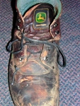 The wearer of this John Deere boot had the misfortune of having a 1,300-pound section of a combine fall on his foot one day.