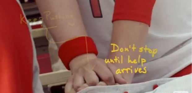 This image is a screen capture from an American Heart Association video promoting hands-only CPR.
