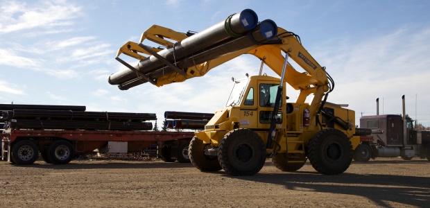 Typical loader lift arms tend to obstruct front visibility, while an overhead lift arm design provides full forward visibility when lifting, placing, and transporting loads. (Pettibone Heavy Equipment Group photo)