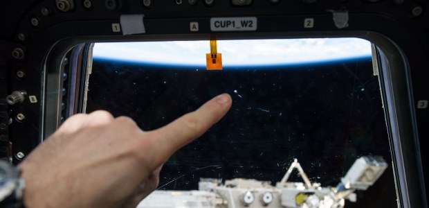 This NASA photo shows the mark left on a window of the International Space Station’s Cupola by a micro meteor orbital debris strike. The Space Debris Sensor will measure the orbital debris environment for two to three years, according to NASA.