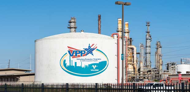 oil tank refinery with VPP logo on it (vpp logo is a red and white swoop with the letters VPP in blue and a star after the letters, also in blue)