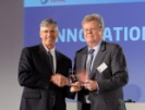 Alan Brown (left), health supervisor for Total Petrochemicals & Refining USA, Inc., received an innovation award from Michel Benezit of Total SA for improving safety while reducing costs. (Total Petrochemicals & Refining photo)
