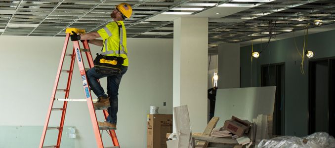Construction worker on ladder