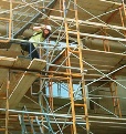 An image of a worker standing on a scaffold.