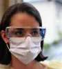 a worker wears a protective mask covering her nose and mouth
