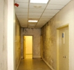 a hallway with surfaces showing moisture buildup
