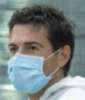 a worker wears a medical mask for protection against disease