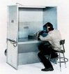 This DualDraw, LLC photo shows a worker using the TB3048 downdraft booth with vented back.