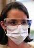 a health worker wears a medical mask and protective eyewear
