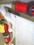 An image of an occupant use fire hose and a fire extinguisher.