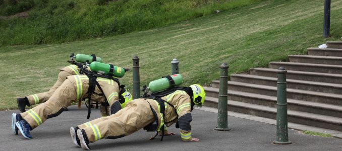Firefighters in Gear Exercising 