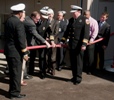 This NNSA photo shows Mike Thompson of NNSA and Nevada National Security Site Fire Chief Charles Fauerbach decoupling a fire hose to open the new Fire Station No. 1 in October 2010. Looking on are representatives from the Nevada congressional delegation and Nevada Site Office management.