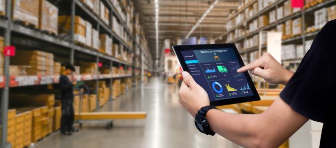 Worker holding tablet in warehouse