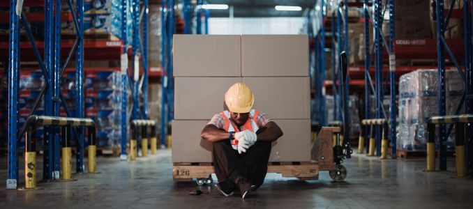 Exhausted Plant Worker with Head Down