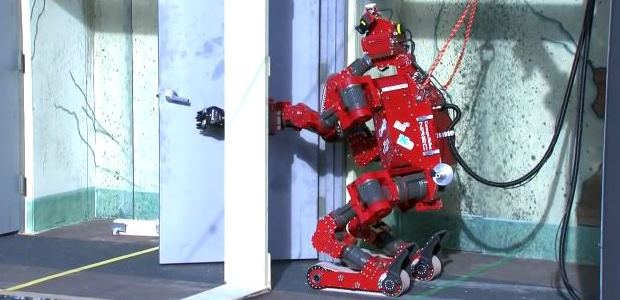 Carnegie Mellon University-NREC designed CHIMP (CMU Highly Intelligent Mobile Platform) is shown during the 2013 DARPA Robotics Challenge Trials task of opening a series of doors. CHIMP finished third in the trials. (DARPA image)