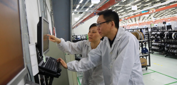 Tan Huan (front), section manager of Planning, and Dai Lan, Inventory Control manager, confer while working in the Jabil Shanghai facility. "This improvement has solved the problem of low efficiency and human error that we previously experienced with paper-based systems," Dai Lan said. "The shift from manual to system control of materials provides a clear, accurate status for the plant."