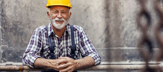 Senior worker leaning on guard rail