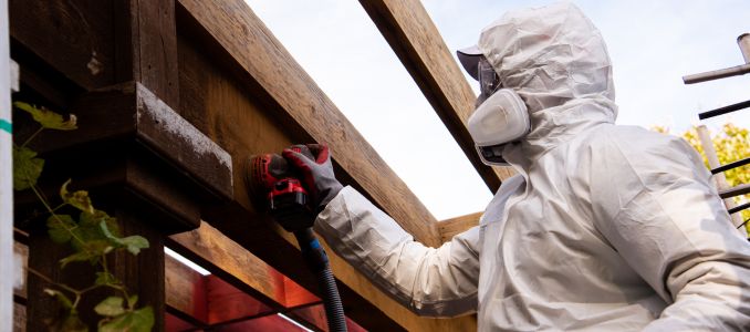 man in full body hazmat suit, respirator mask, gloves, safety glasses goggles protection
