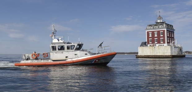 A 45-foot Response Boat - Medium from Coast Guard Station New London (Conn.) transits near the New London Ledge Light at the entrance to the Thames River on April 14, 2017. (U.S. Coast Guard photo by Petty Officer 3rd Class Steve Strohmaier)