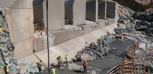 Kiewit Infrastructure workers placed leveling concrete for an access road below four energy dissipator blocks at the Oroville Dam