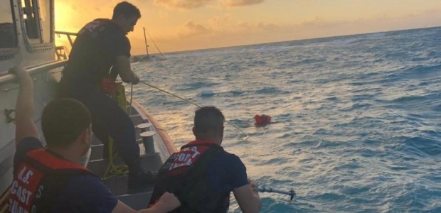 A Coast Guard Station Islamorada 45-foot Response Boat-Medium crew pulls a man toward the boat near Key Largo on Feb. 21, 2019. (Coast Guard Photo by Petty Officer 2nd Class Michael Shortes)