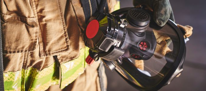 a firefighter holding an oxygen mask