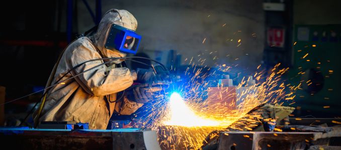 Worker with Blow Torch Wearing PPE