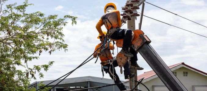 Electricians Working on a Pole