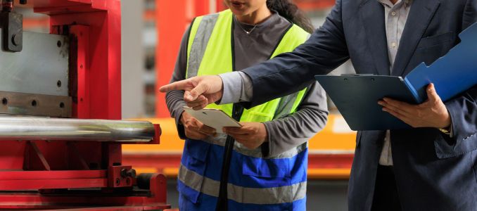 Industrial manager and engineer inspecting on safety on production line and storage in factory