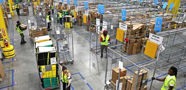 above view of workers moving packages in an Amazon delivery station.