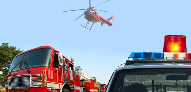 a fire truck, helicopter and police car against the sky