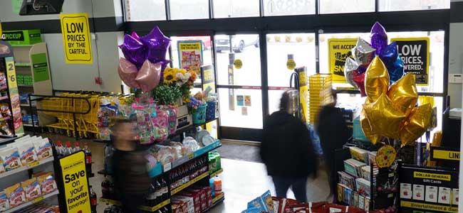 People walk toward an exit in a Dollar General store