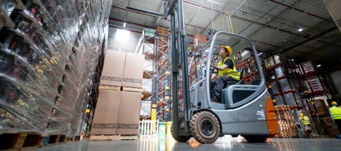 Warehouse worker operates a forklift
