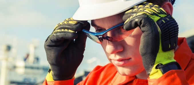 Engineer putting on safety glasses