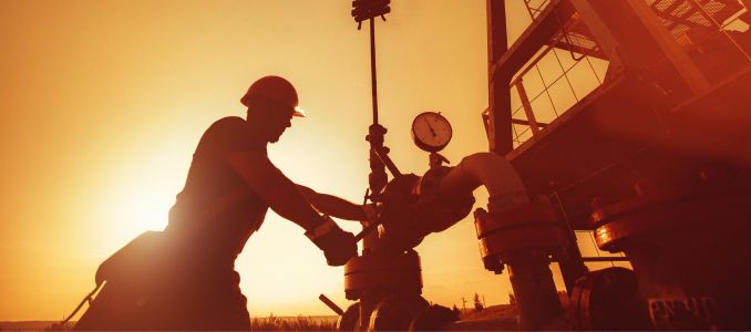 Worker checking oil pump